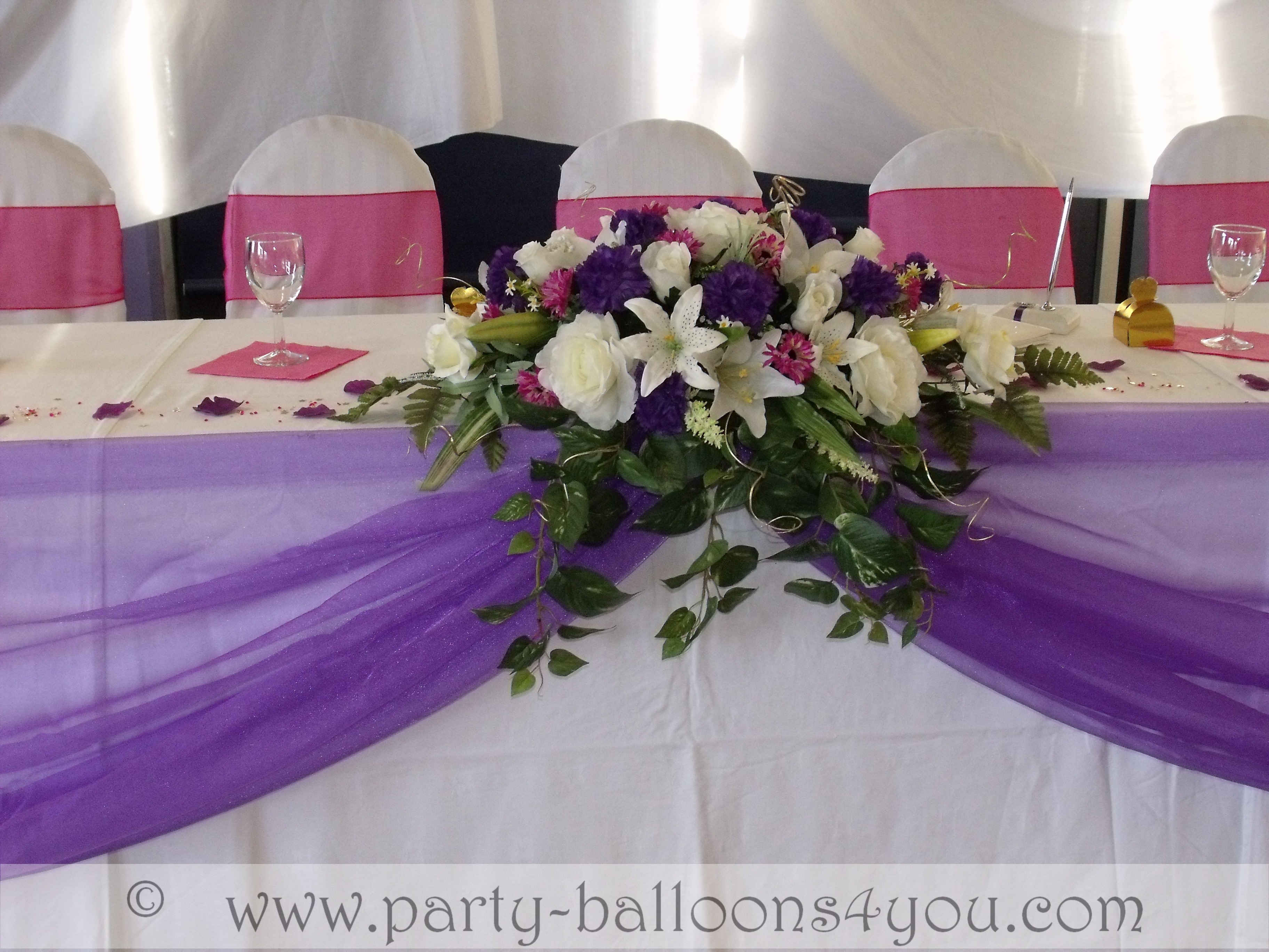  table with a organza swag with a silk flower low and long flower